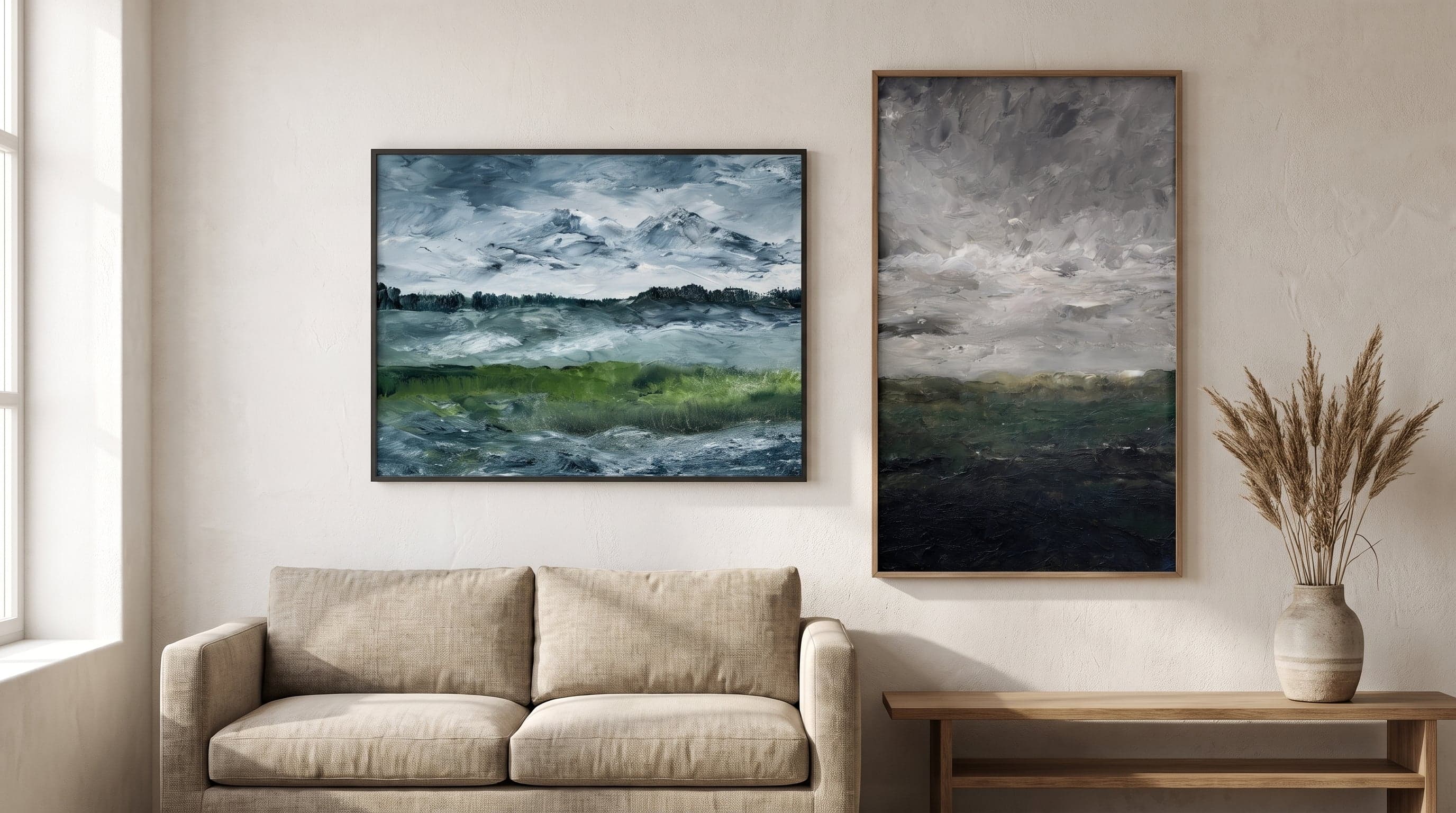 Minimalist living room featuring two framed landscape art prints in calm earthy tones.