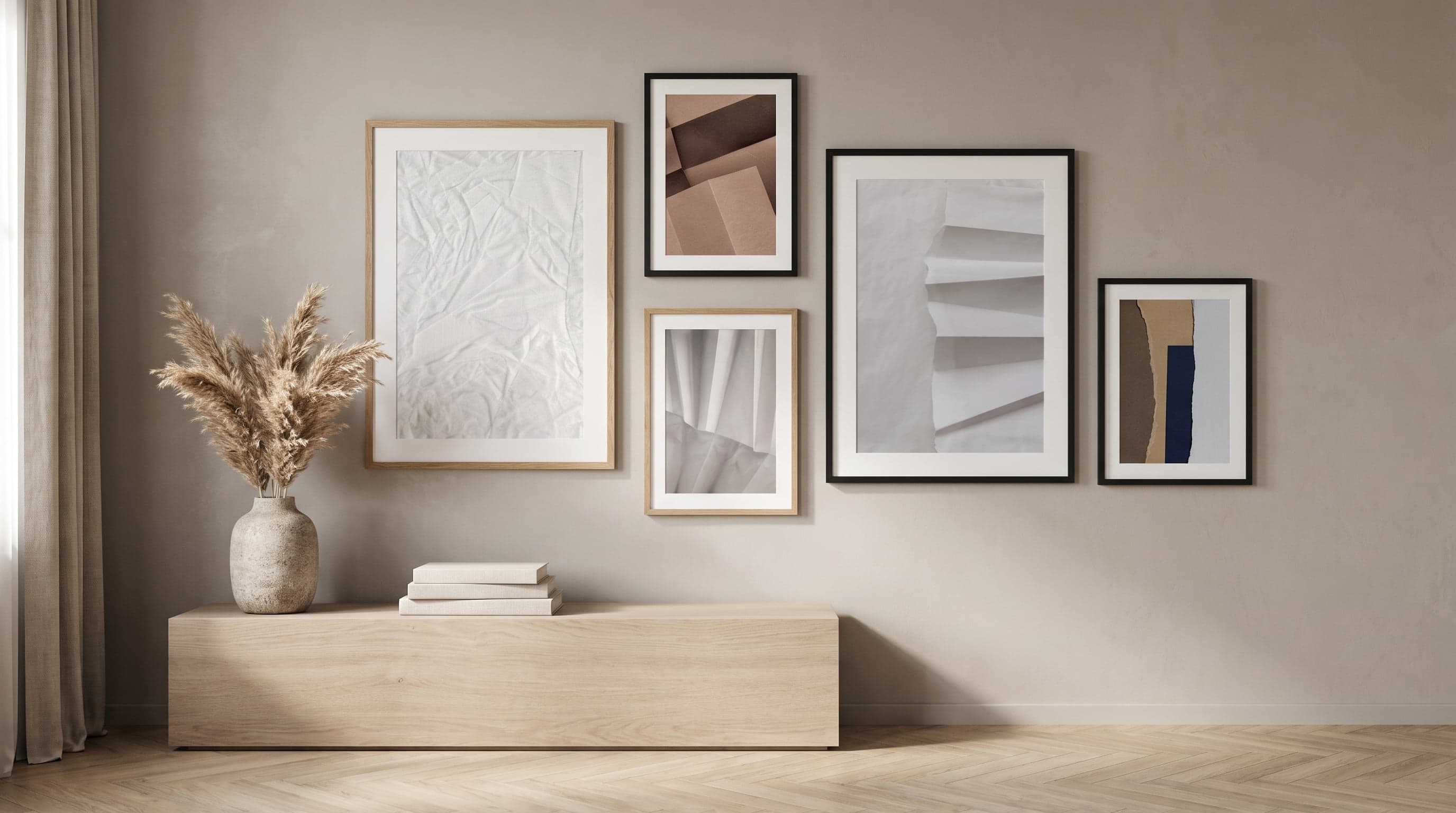 Gallery wall of paper study prints in varied frames, light revealing texture and sheen.