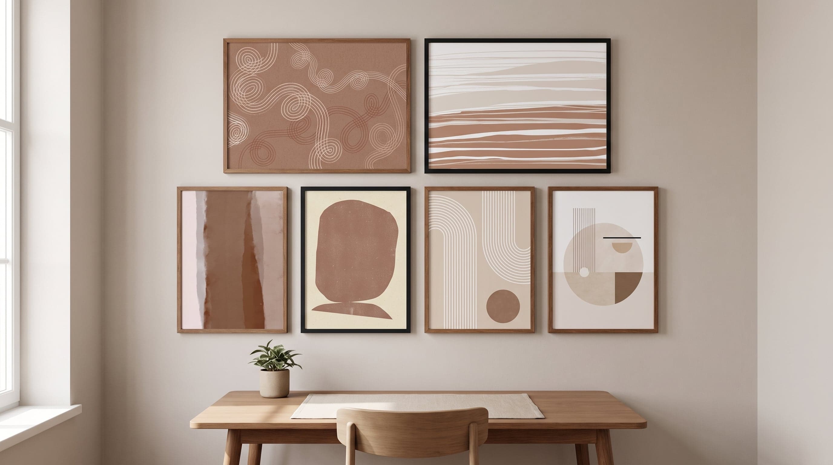 Calm office wall with six neutral posters in muted earth tones above a minimalist desk.